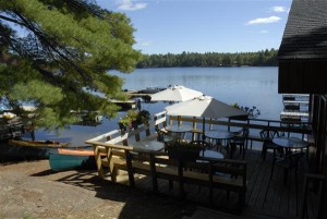 Deck outside restaurant at Blue Mountain Lodge overlooking Lake Kasshabog
